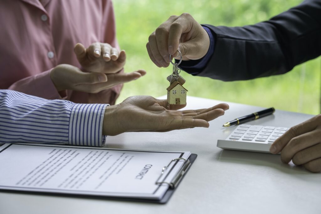 Real estate broker and client sign contract insurance agreement document. Home Insurance and Real es